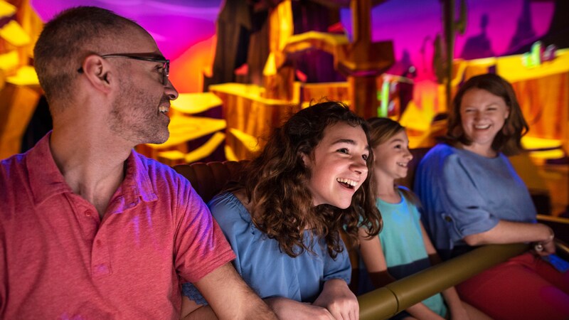 A family of 4 riding Mickey & Minnie's Runaway Railway at Disney's Hollywood Studios theme park