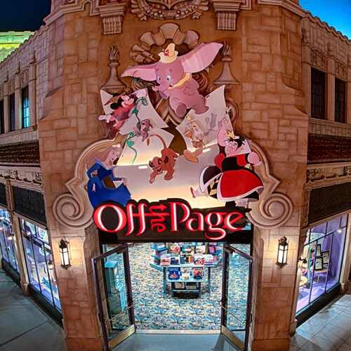 Vibrant lights illuminate the exterior of Off the Page as Disney characters cascade down its signage