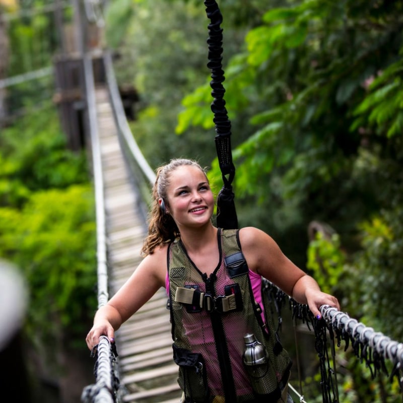A woman crosses a bridge at Disney’s Animal Kingdom theme park