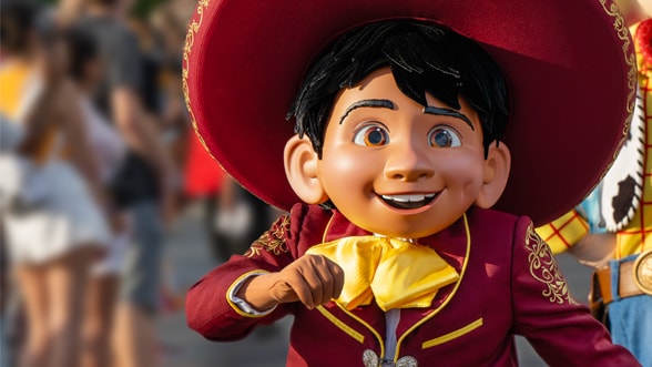 Miguel walking in the Disney Adventure Friends Cavalcade