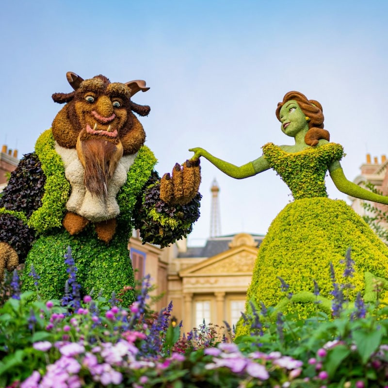 Belle and Beast topiaries holding hands at the France Pavilion in Epcot