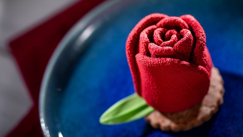Milk Chocolate Rose with raspberry and rose center atop a cookie on a plate