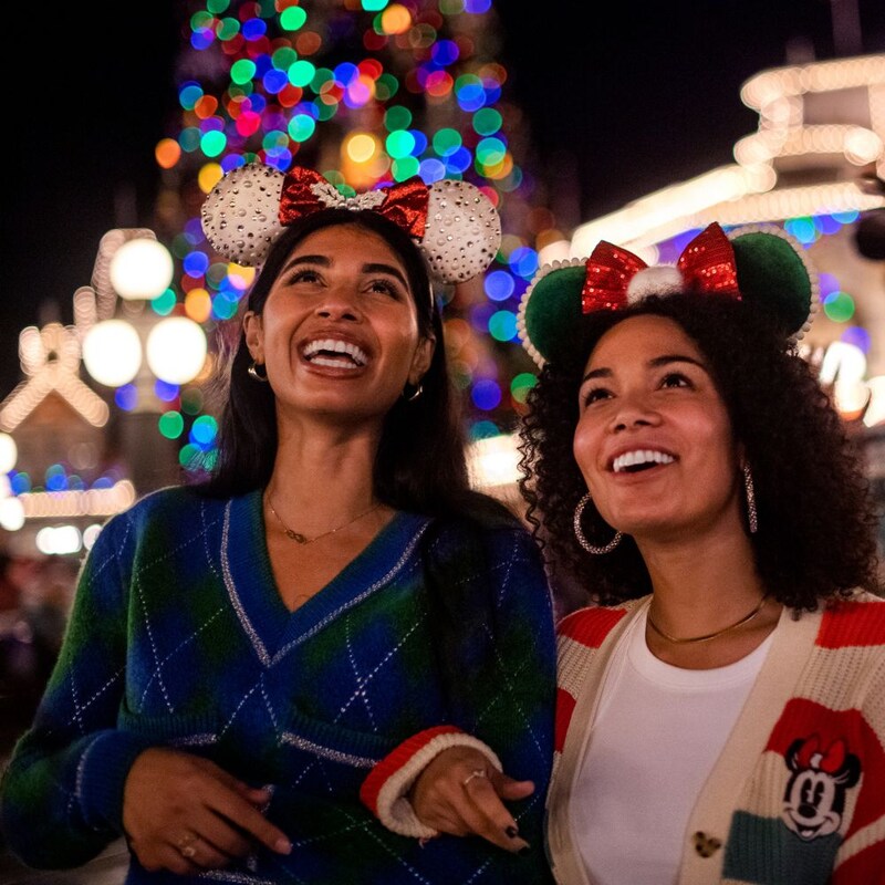A family of 4 experiencing snowflakes during Holidays at Walt Disney World Resort