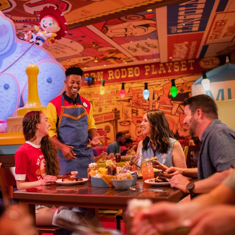 A table of 3 Guests speaking with the server at Roundup Rodeo BBQ
