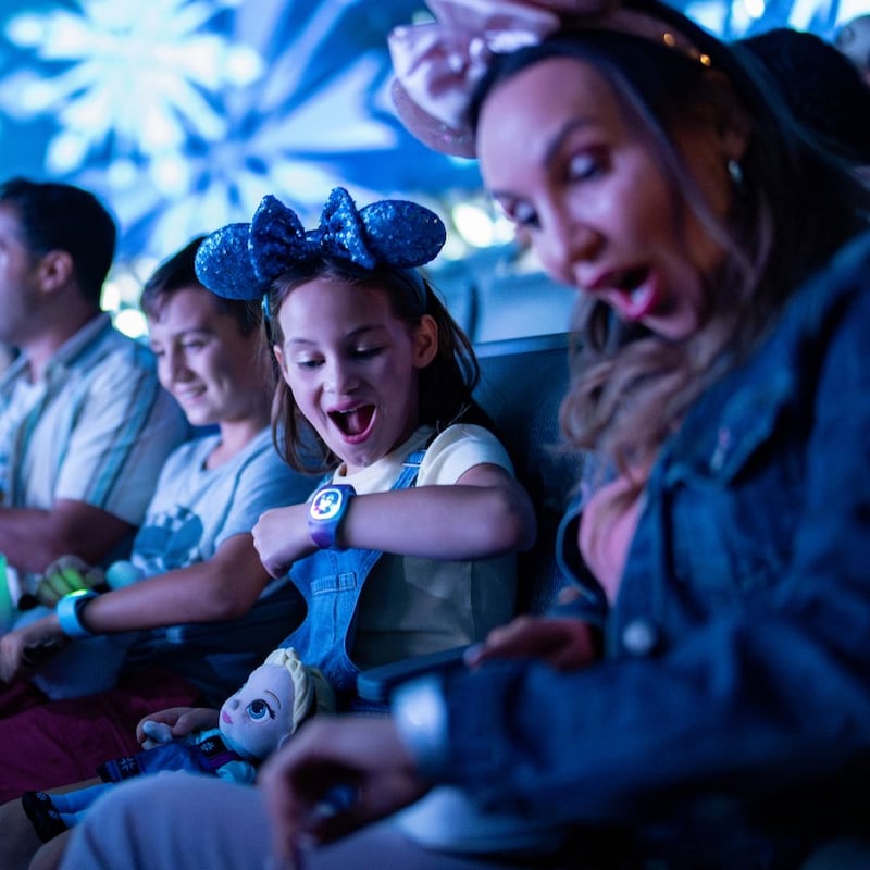 A MagicBand Plus worn on a Guest’s wrist lights up during For the First Time in Forever: A Frozen Sing-Along Celebration at Disney’s Hollywood Studios theme park.