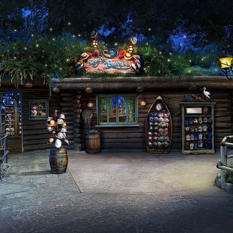 A cabin with grass on the roof, merchandise displayed out front and a sign that says 'Ray's Berets'