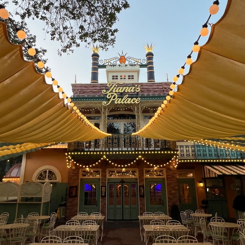 Tiana's Palace restaurant entrance under decorative string lights and canopies