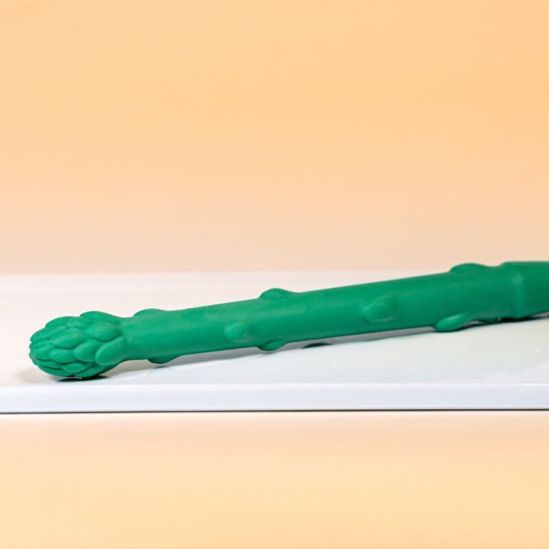 An oversized asparagus shaped novelty food item on a white tray, available during Bluey's Best Day Ever