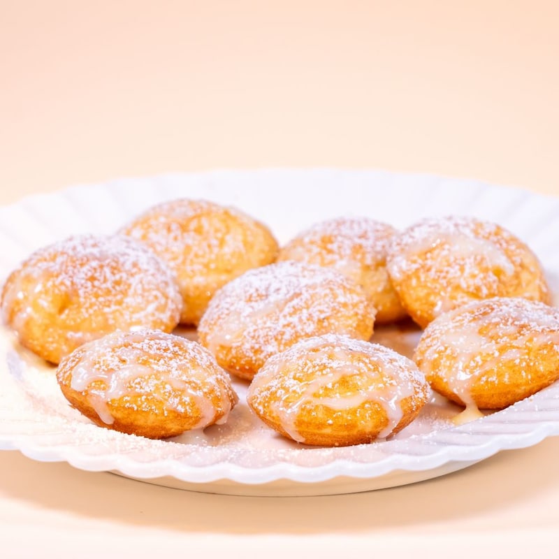 Powdered sugar dusted pastry bites with glaze, available during Bluey's Best Day Ever
