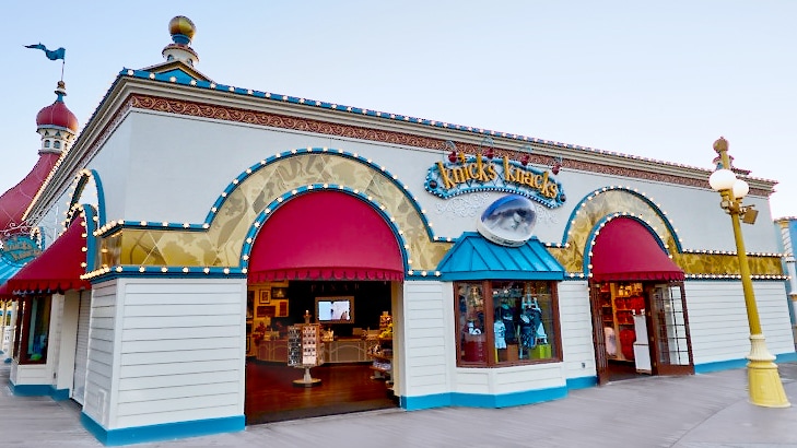 Neon lights wrap around the exterior of Knicks Knacks, a souvenir store