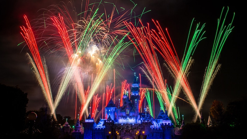 Festive fireworks and lasers lighting up the sky above Sleeping Beauty Castle.