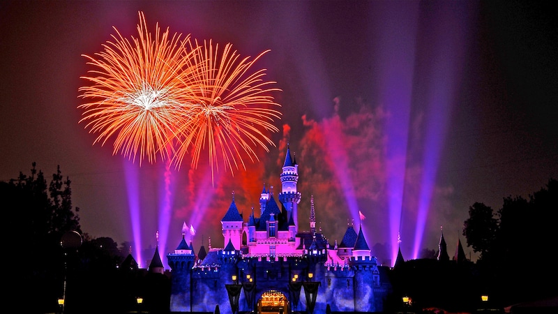 Bursting fireworks above Sleeping Beauty Castle at night