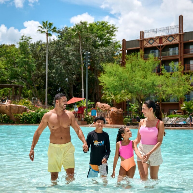 A family of 4 standing in the shallow end of the pool at Disney's Animal Kingdom Lodge