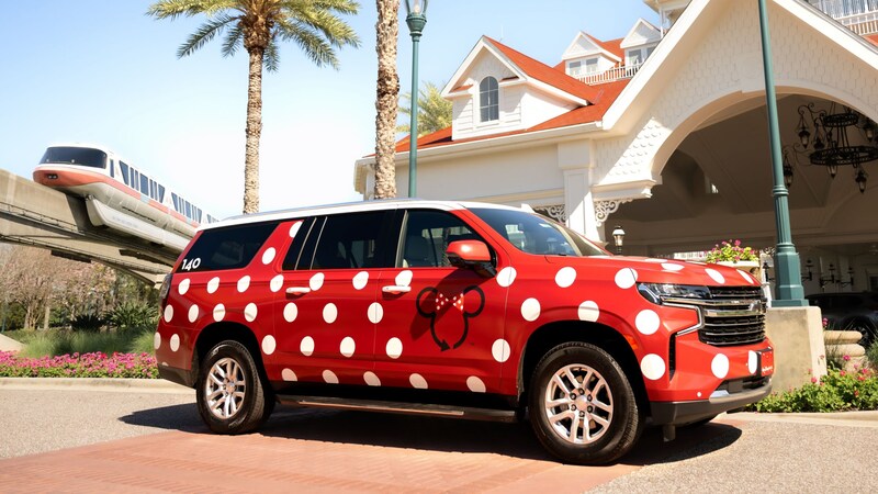  A polka dot SUV with a Minnie Mouse design parked outside of Disney's Grand Floridian Resort