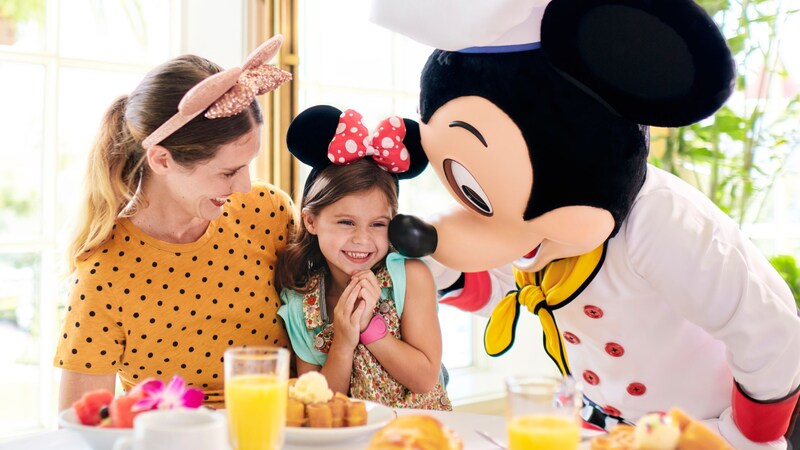  Chef Mickey greeting a mother and child at a breakfast table 