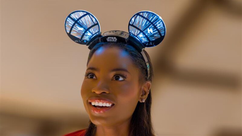 A Guest wearing an illuminated Star Wars themed Mickey Mouse ear headband while inside Millenium Falcon, Smugglers Run