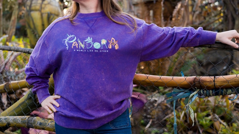 A Guest in a sweatshirt reading ‘Pandora, a world like no other’