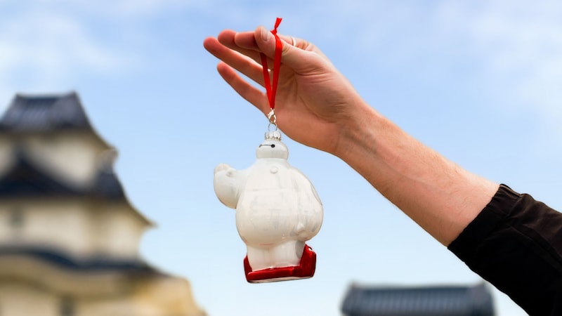 A hand holding a Baymax ornament