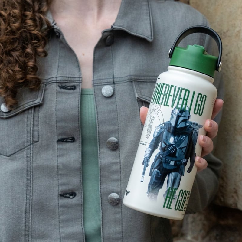 A Guest holding a Mandalorian themed water bottle