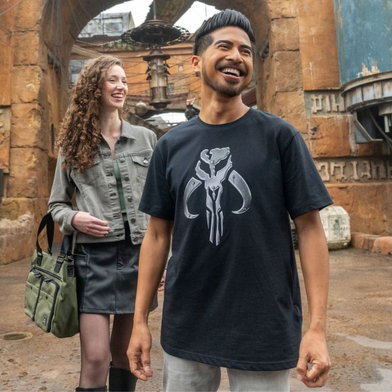 A couple wearing Mandalorian themed apparel at Star Wars Galaxy’s Edge