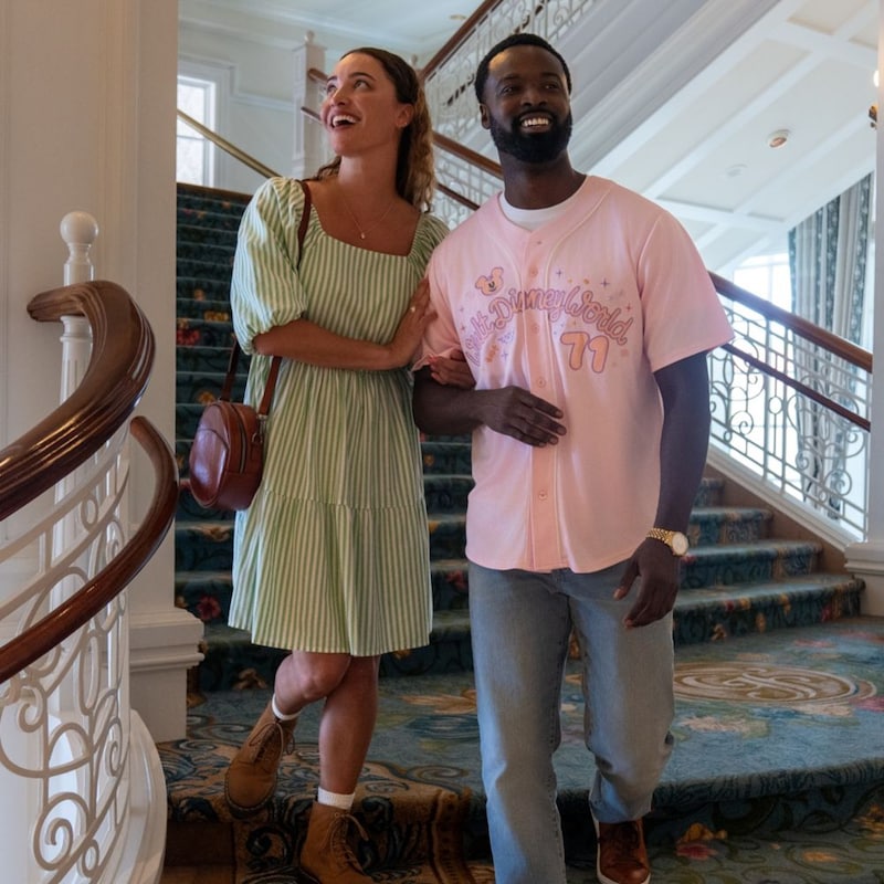2 Guests laughing while descending a grand staircase at Disney's Grand Floridian Resort & Spa