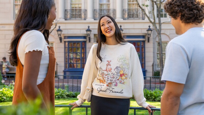 A Guest wearing a Winnie the Pooh sweatshirt while hanging out with 2 other Guests