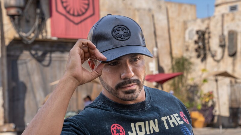 A man wearing an Imperial baseball cap and T shirt at Star Wars Galaxy’s Edge