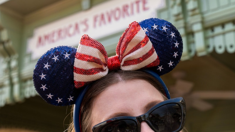 A Guest wearing a Minnie Mouse ear headband commemorating America’s 250th Independence Day