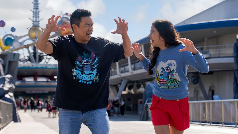 Two Guests wearing Stitch T shirts posing with their hands up