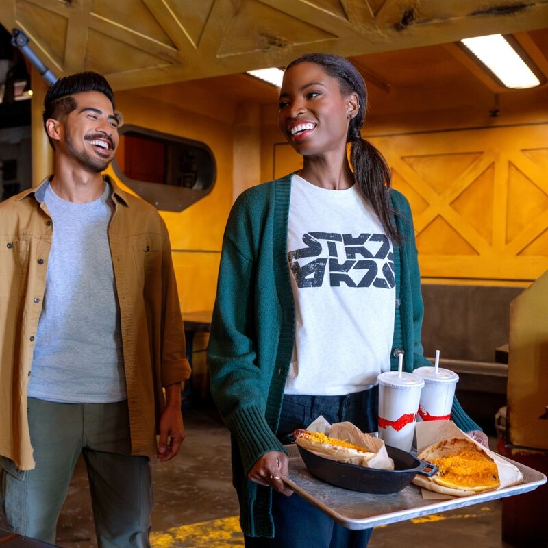 Two guests picking up food at Docking Bay 7 Food and Cargo at Disney's Hollywood Studios theme park