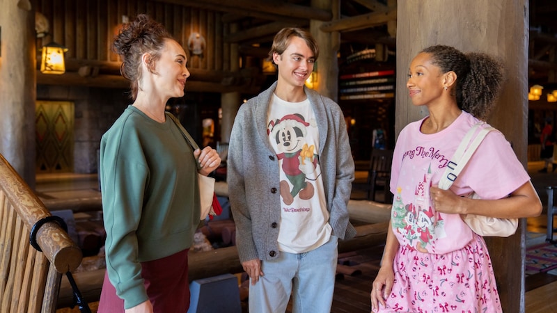 Three friends wearing merchandise from the Disney Holiday Collection