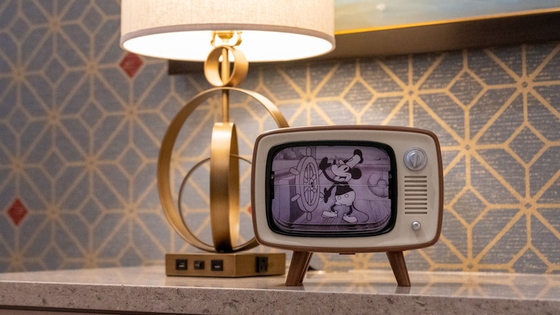 A device shaped like a vintage television displaying an animated Mickey Mouse scene