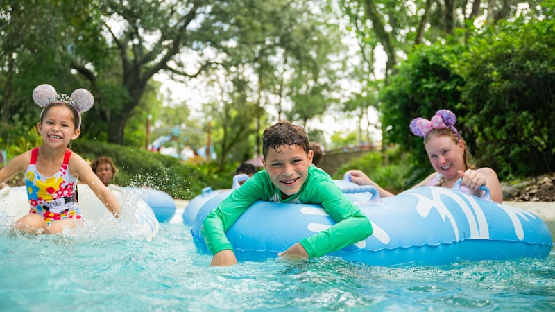 Three Guests riding the Castaway Creek attraction at Disney's Typhoon Lagoon water park