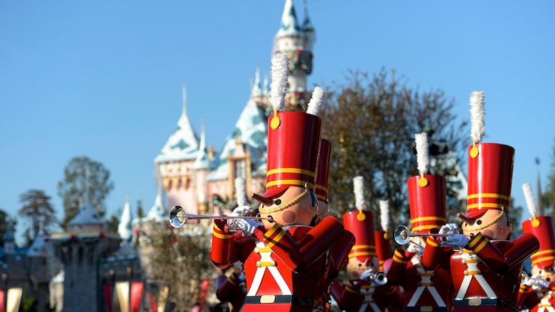  Toy soldiers, playing trumpets, marching down Main Street USA