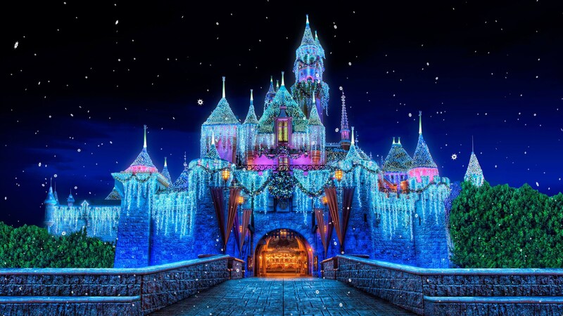 El Castillo de la Bella Durmiente decorado con luces durante una celebración nocturna de invierno