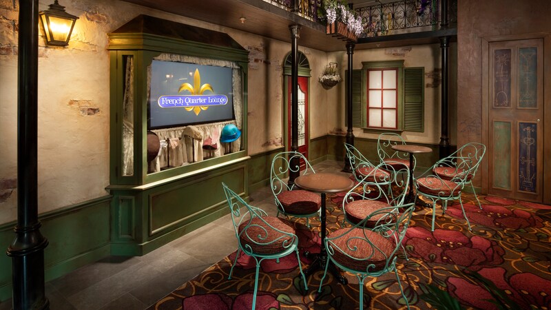 Tables and chairs in a corner of the French Quarter Lounge designed to resemble a New Orleans street corner