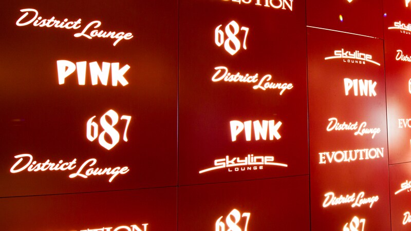 A lit sign lists lounges on the ship, including 687, District Lounge, Pink, Skyline Lounge and Evolution