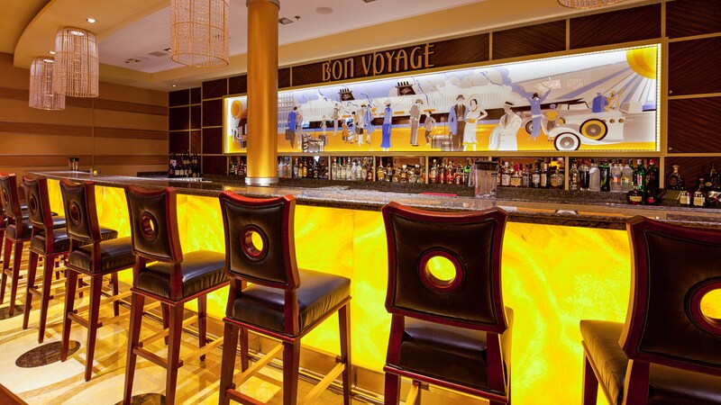 The Bon Voyage bar has an art mural above the bar and high backed barstools