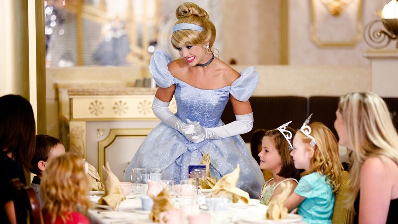 Cinderella greets a table filled with young girls excited to meet her