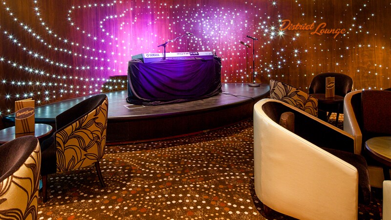 The District Lounge has a stage with microphones and sound equipment set up