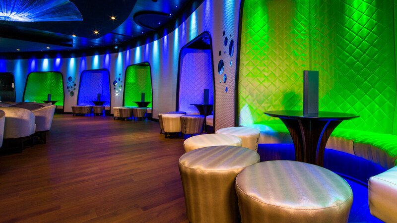 Stools and benches surround a cocktail table in a roomy lounge space