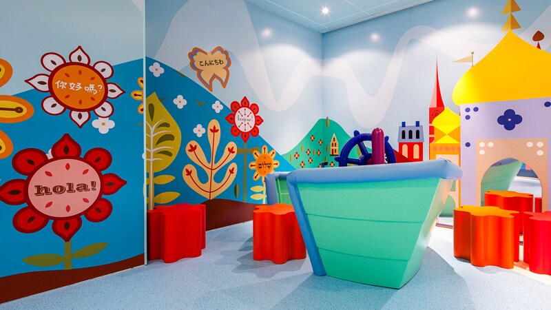 A play area with 3 dimensional decorations of the small world attraction, at Its a Small World Nursery