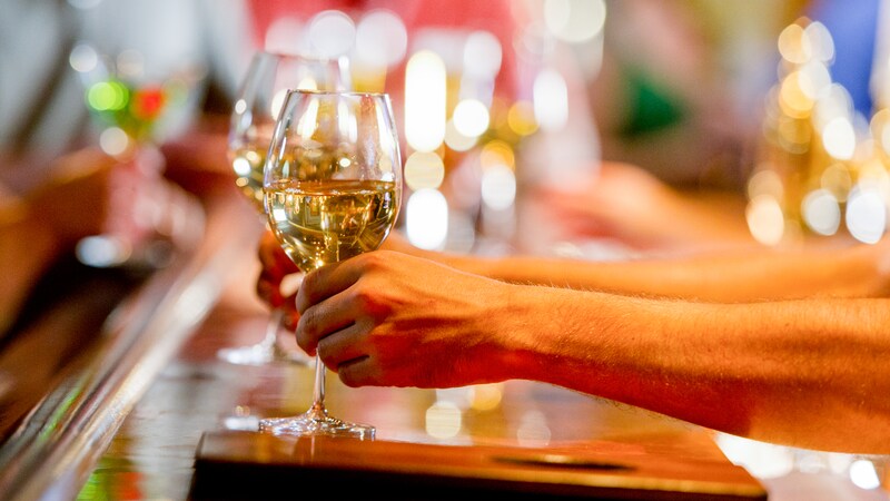 Two glasses of chardonnay are placed on a bar for 2 Guests