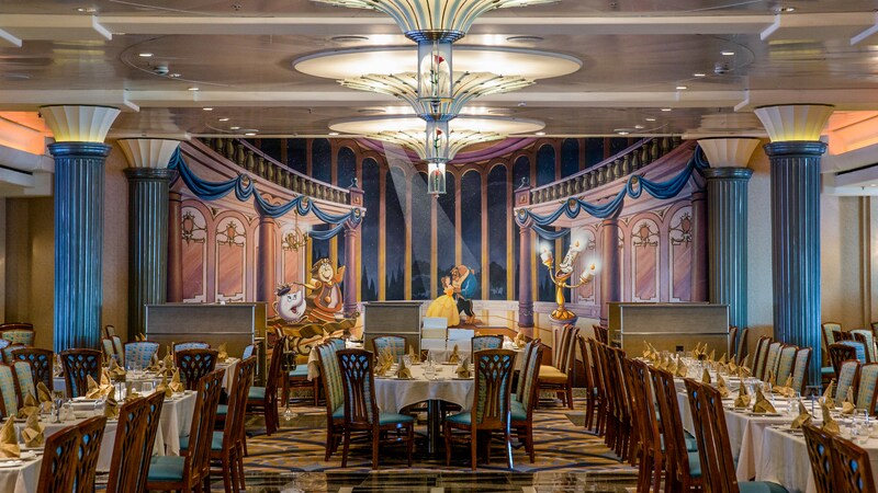 A grand dining room with rose flowers in glass domes, Art Deco columns and a mural with Disney characters