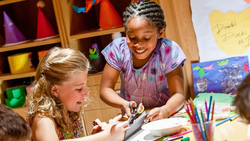 Kids create crafts in the Craft Studio at Disneys Oceaneer Lab on the Disney Dream