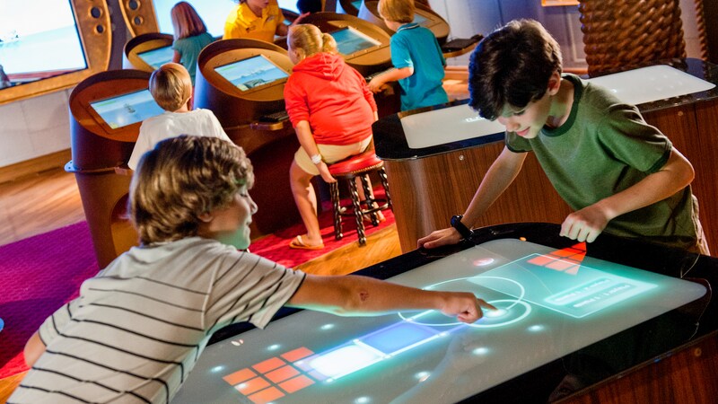 In the ocean themed Wheelhouse room at Disneys Oceaneer Lab, kids play high tech interactive video games