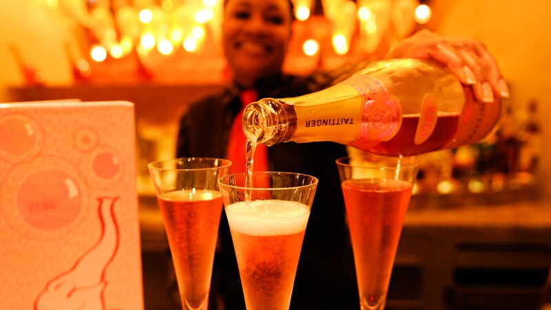 A sign against a wall says Pink in large letters