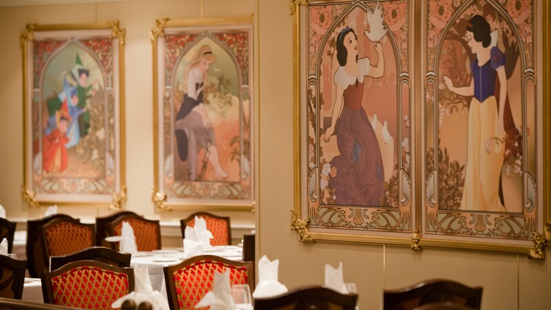 Mosaic tile murals of Cinderella, Snow White, Belle and Sleeping Beauty on a wall, at the Royal Court restaurant