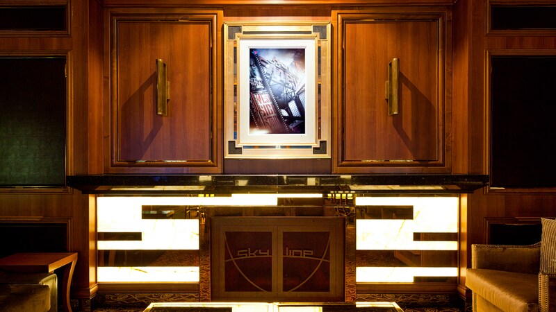 An art print hangs between 2 wooden panels in the Skyline Lounge