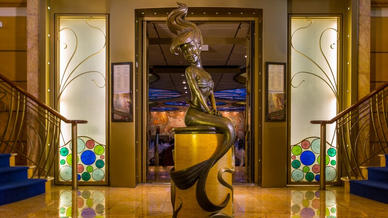 A metal sign with a trident, a weapon featured in the Disney film The Little Mermaid, says, Tritons